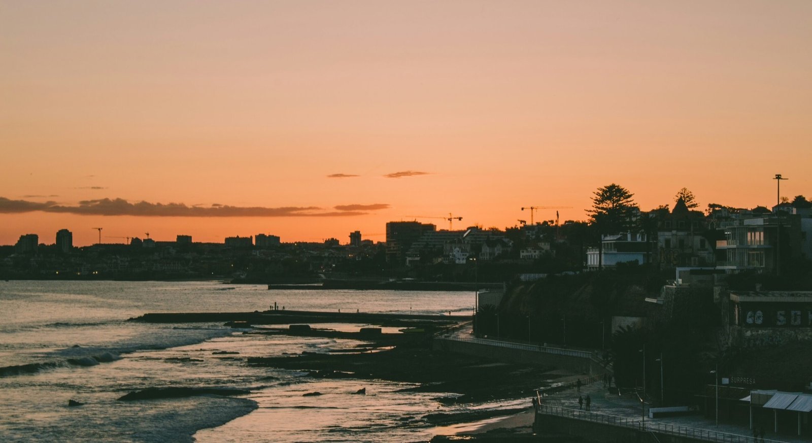Warm evening light along the Estoril coast and seaside promenade