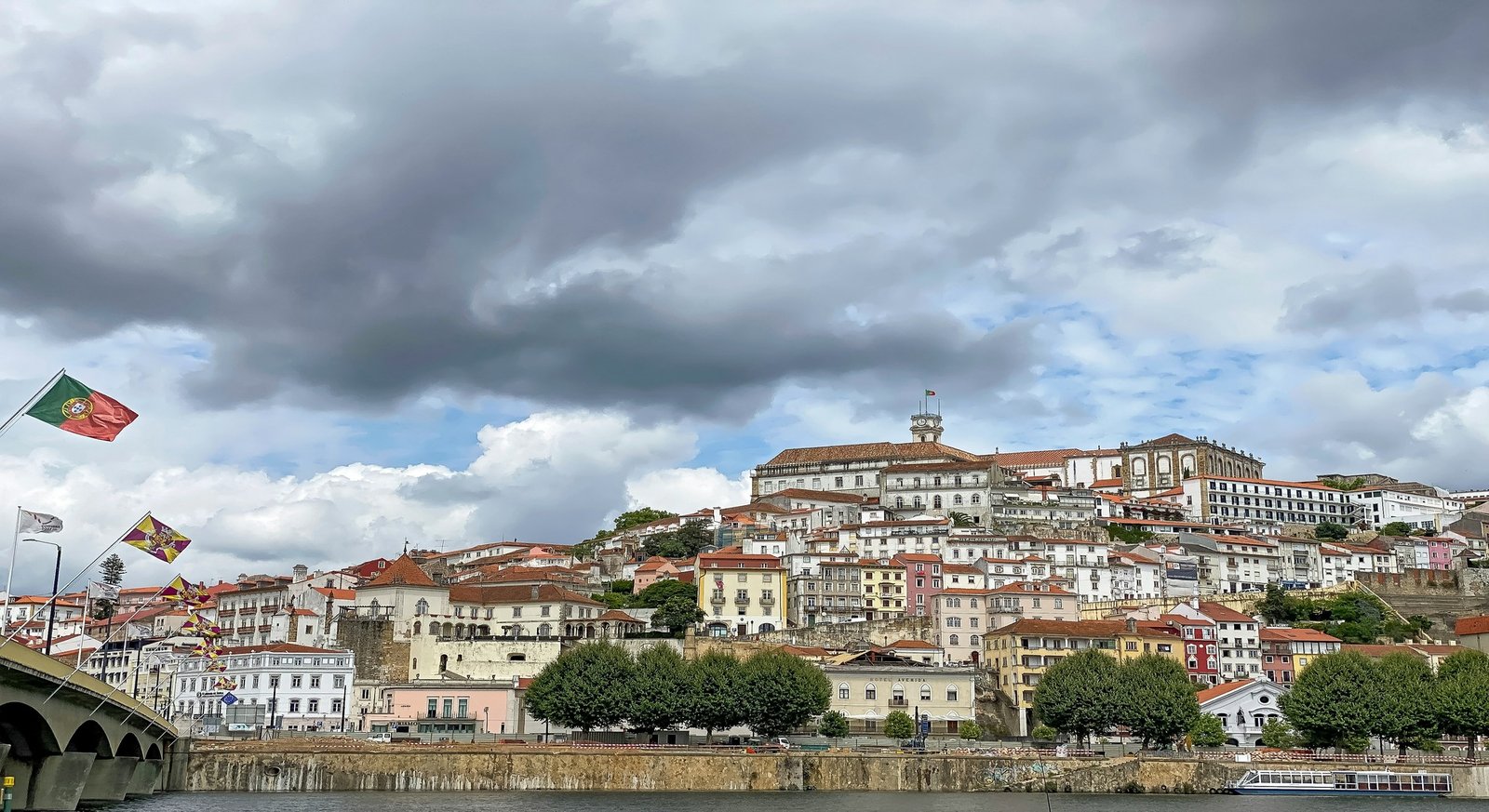 Scenic riverfront view of Coimbra and Santa Clara bridge