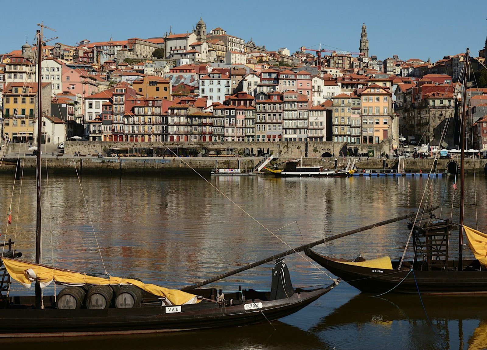 Rabelo boats on the Douro with Porto’s colourful Ribeira waterfront seen from Gaia