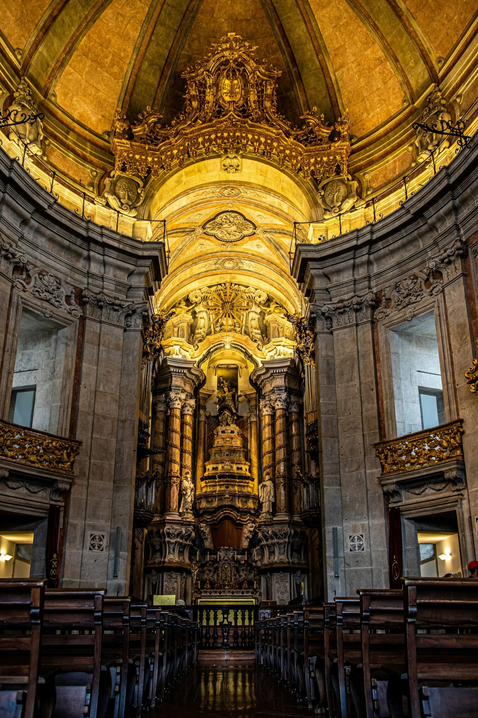 The gilded altar and vaulted interior of the Church of the Clérigos in Porto.