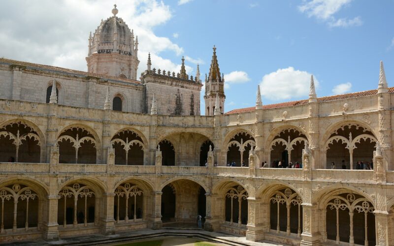 Stone arches frame the courtyard of Jerónimos Monastery in Lisbon.