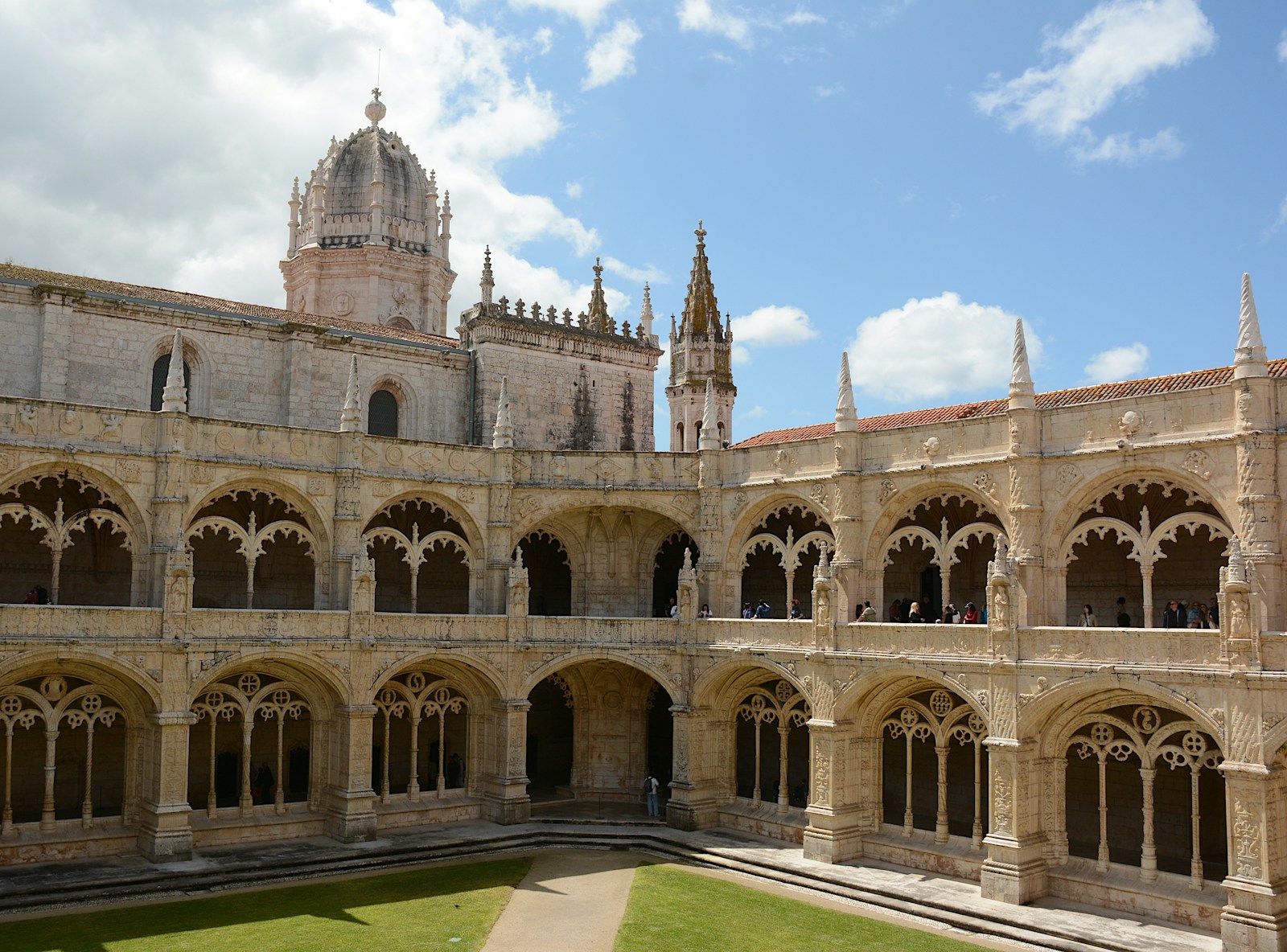Stone arches frame the courtyard of Jerónimos Monastery in Lisbon.