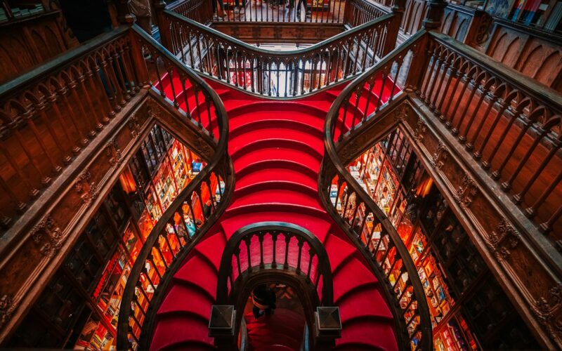 The crimson staircase inside Livraria Lello in Porto.