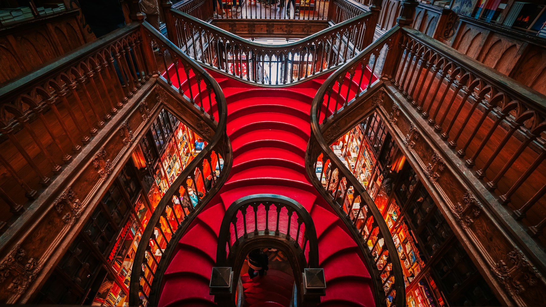 The crimson staircase inside Livraria Lello in Porto.