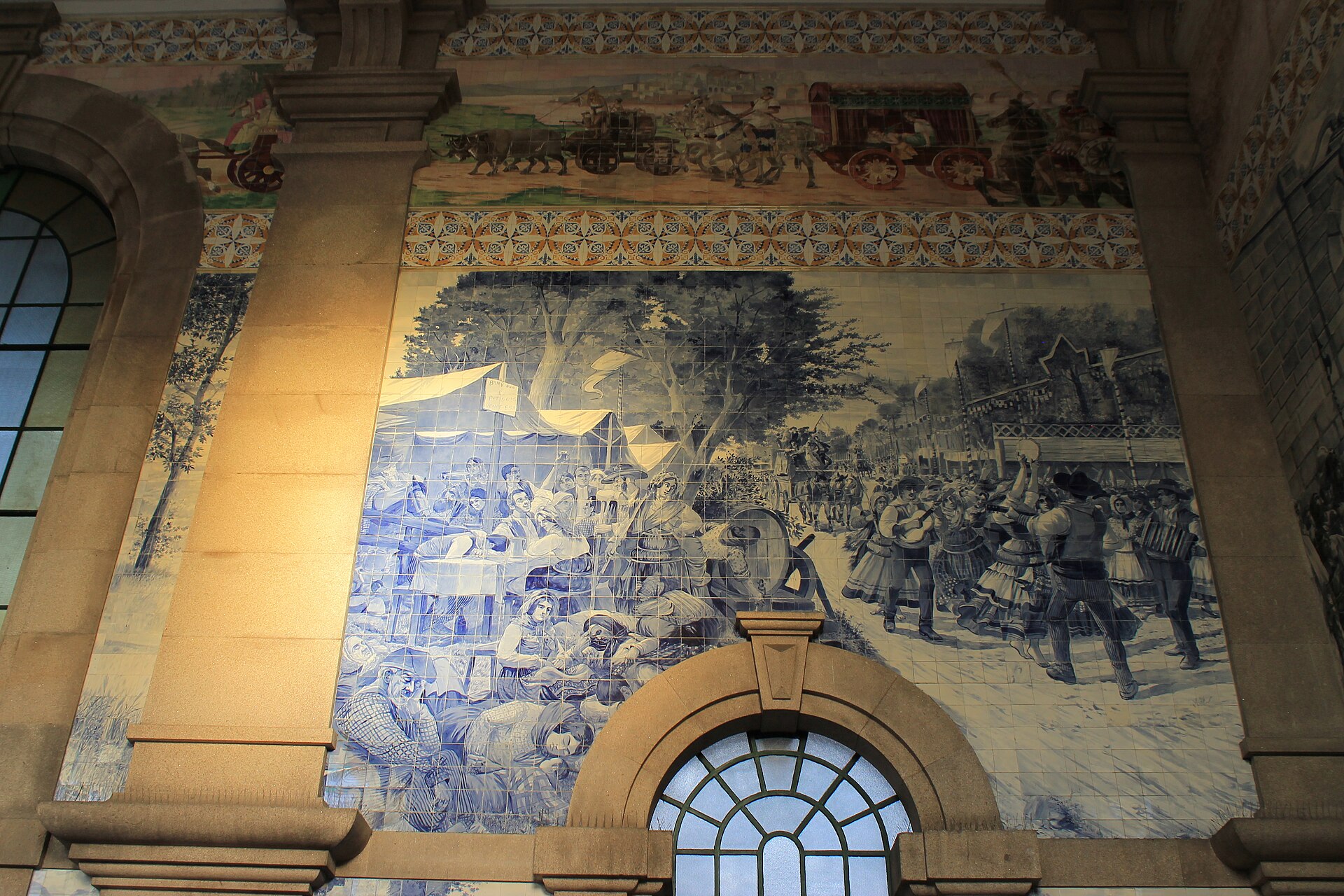 Azulejo panel depicting people and a festive scene in São Bento station in Porto