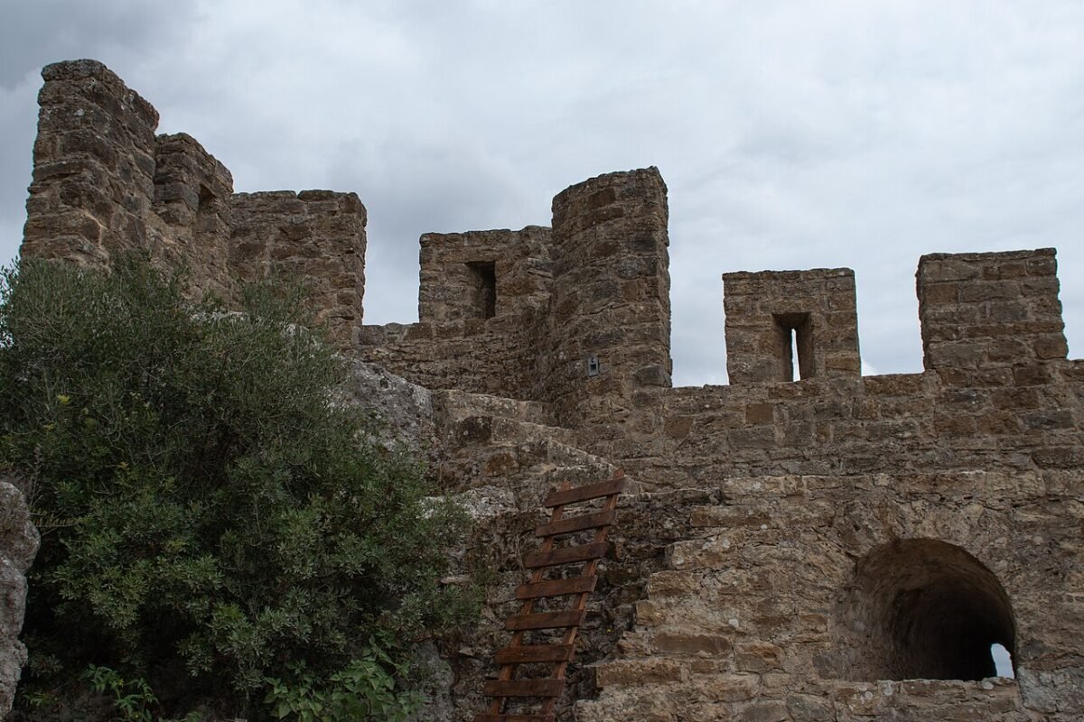 Stone battlements and a wooden ladder inside the castle walls of Óbidos.