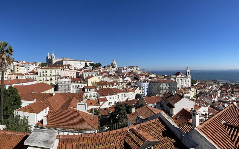 Panoramic view across Lisbon’s rooftops from Bairro Alto towards the Tagus.
