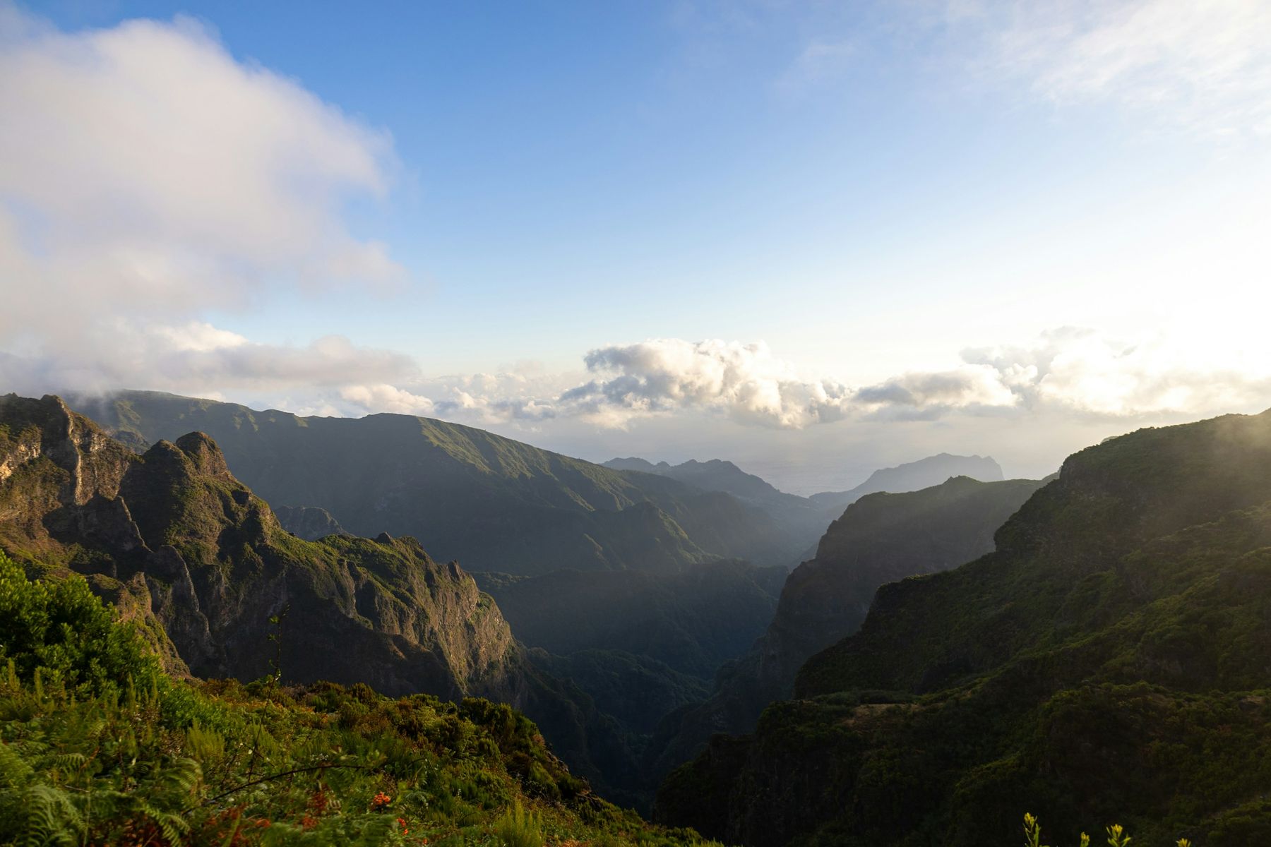 Mountain ridges and valleys near Pico do Areeiro beneath clouds and morning light