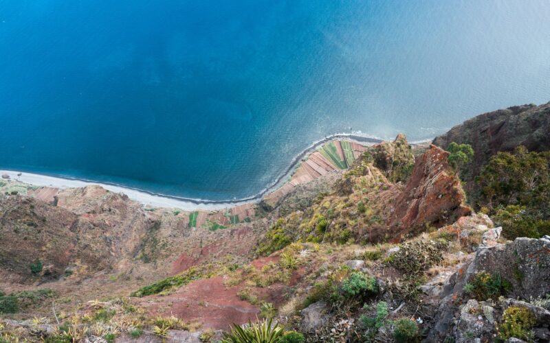 Coastal farmland and the Atlantic seen down the steep cliff at Cabo Girão