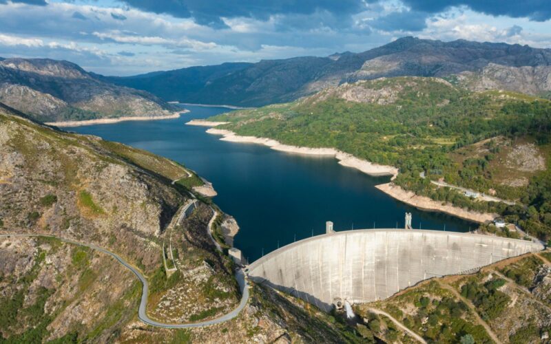 Reservoir, curved dam and granite mountain slopes in Gerês