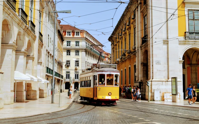 Traditional yellow tram travelling through Lisbon, Portugal