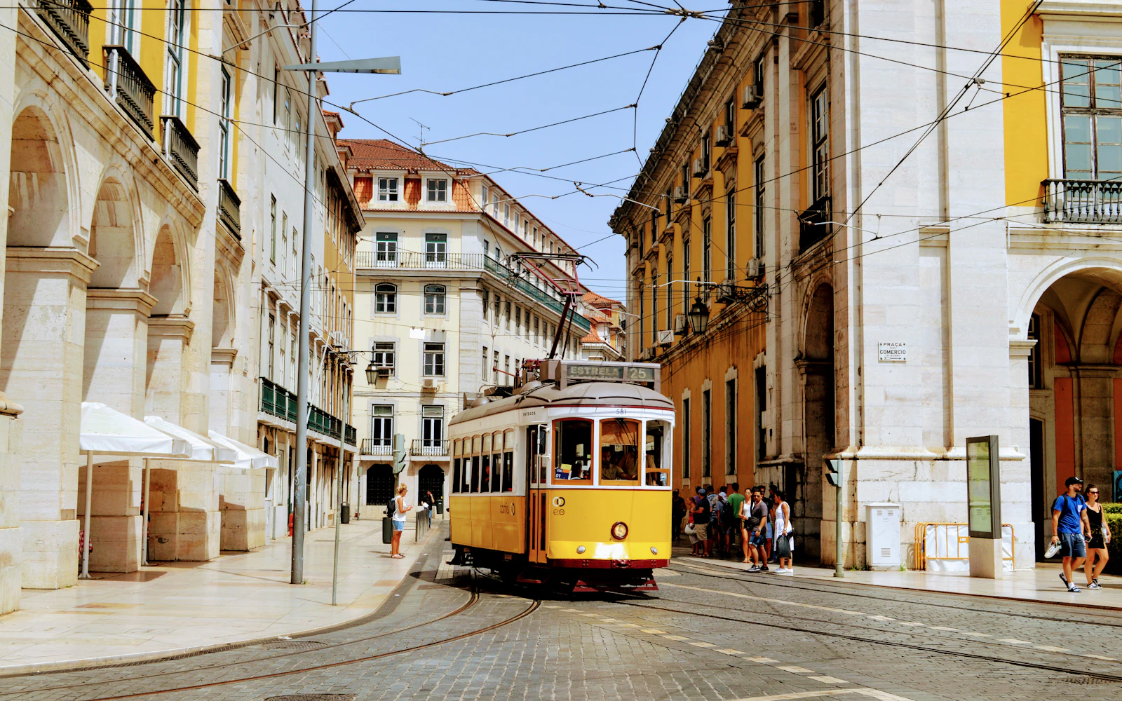 Traditional yellow tram travelling through Lisbon, Portugal